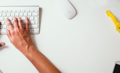 person typing on Apple Cordless Keyboard